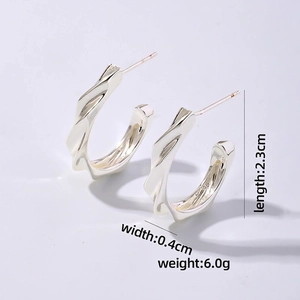 Detail view of silver C-shaped twist earrings with dimensions 2.3cm by 0.4cm and weight 6.0g