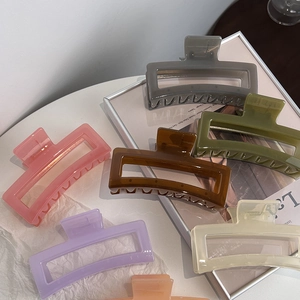 Detailed view of large rectangular hair claw clips in assorted glossy jelly colors