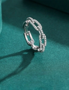 Macro shot of silver S925 sterling silver chain ring with pavé-set sparkling zircons
