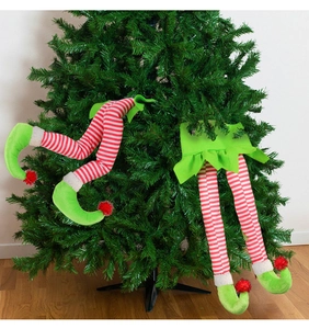 Detail of plush Christmas elf legs with red white stripes and green shoes for tree decor