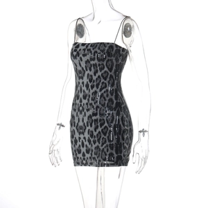 Close-up of leopard print sequin fabric and adjustable spaghetti straps on mini dress