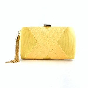 Detail of yellow satin evening clutch featuring elegant fringe and gold metal top clasp
