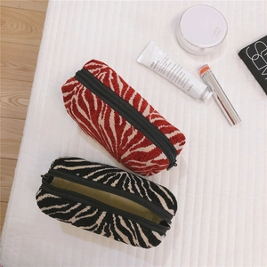 Zebra pattern boat-shaped cosmetic bags with top zippers in red and black knit textures
