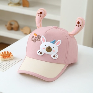 Detail of pink and beige kids baseball cap featuring 3D bunny ears and cute rabbit patch