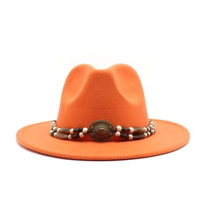 Detail of orange wool fedora with bohemian beaded band and vintage metal buckle