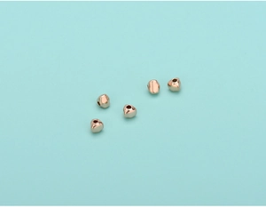 Macro detail of rose gold S925 sterling silver triangle spacers for jewelry making