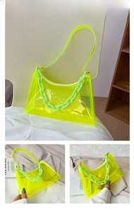 Detail of neon green transparent PVC baguette bag with chunky plastic chain and zipper