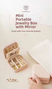 Pink faux leather travel jewelry box with mirror and ring slots interior view