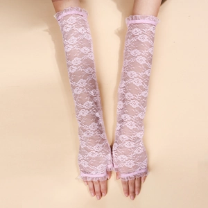 Close-up of elegant pale pink floral lace gloves with delicate ruffled edges and fingerless style