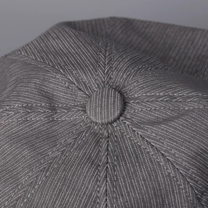 Detailed top view of grey striped octagonal hat showing high-quality fabric and stitching