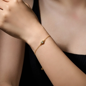 Elegant gold S925 sterling silver evil eye bracelet with sparkling zircons on woman's wrist