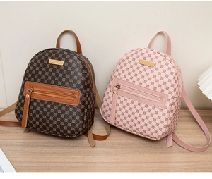 Mini patterned backpacks in dark brown and pink showing leather texture and front pockets