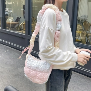 Detail of pink gradient puffer cloud bag with quilted texture shown on a street shoot