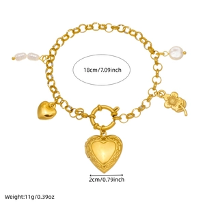 Gold heart pendant pearl bracelet with engraved floral details and spring clasp