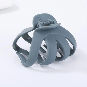 Detail of matte blue-grey octopus hair claw clip with irregular oval geometric design