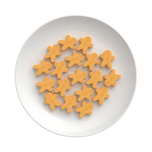 Gingerbread man shaped cookies on a white ceramic plate viewed from a top-down perspective