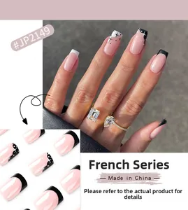 Detail of JP2149 French style press-on nails with black tips and white star patterns
