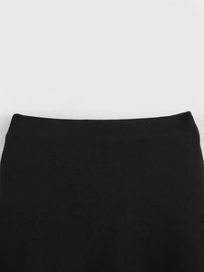 Close-up of the black knitted fabric waistband showing fine elastic texture and neat stitching