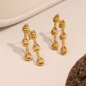 Macro detail of 18K gold-plated teardrop earrings with sparkling cubic zirconia studs