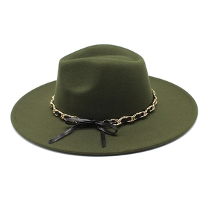 Detail of dark green wool fedora with gold chain trim and a small black bow accent
