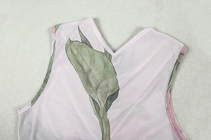 Close-up of V-neckline and tropical leaf print on light pink sleeveless maxi dress