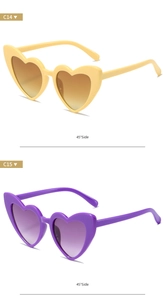 Detail view of heart-shaped glitter sunglasses in yellow and purple at 45-degree angle