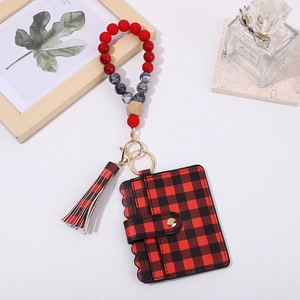 Detail of red buffalo plaid wallet and beaded keychain with silicone and wood beads