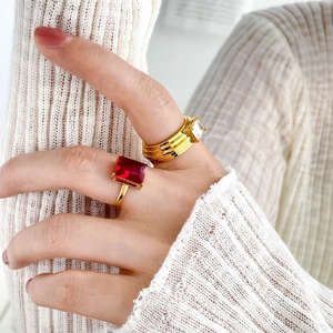 Elegantly layered 18K gold plated rings featuring red and clear square cubic zirconia stones
