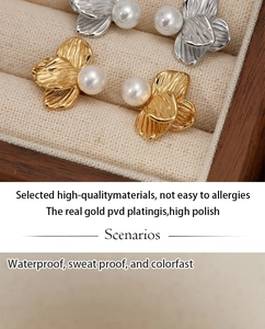 Detailed macro view of gold and silver flower pearl earrings with PVD plating