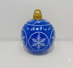 Detail of blue inflatable Christmas ball with white snowflake prints and gold ring hanger