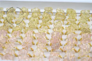 Detailed view of handmade wire-wrapped crystal rings in pink and yellow quartz options