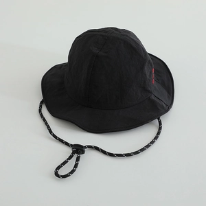 Detail view of black nylon sun hat with red embroidery and adjustable windproof cord