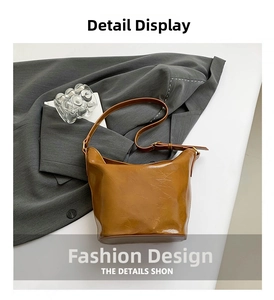 Detail view of caramel brown vintage bucket bag with pleated texture and metal hardware