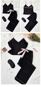 Détail de l'ensemble de pyjama en satin noir avec bretelles roses et masque de sommeil