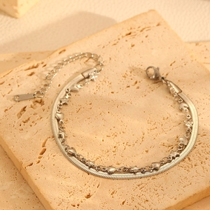 Vue détaillée du bracelet double couche argenté avec breloques étoile et cœur