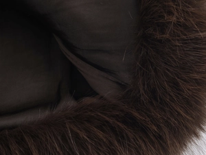 Close-up of the plush dark brown faux fur texture and soft fabric lining detail