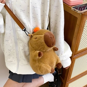 Brown Capybara plush shoulder bag with cute orange head accessory and faux leather strap