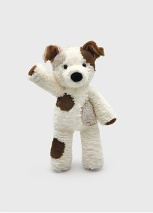 Close-up of curly plush dog toy with brown patches and a raised paw in greeting pose