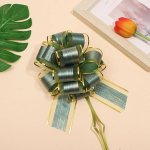 Detail of green and gold checkered ribbon bow on a stylish tabletop with tulip accents