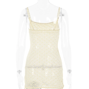 Detail view of the lace floral pattern and adjustable back straps on a sheer mini dress