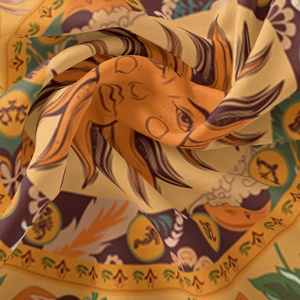 Detail of bohemian sun moon tapestry fabric showing intricate print and silky texture