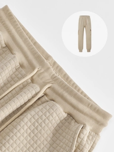 Macro detail of men's khaki waffle textured cargo pants with elastic drawstring waist