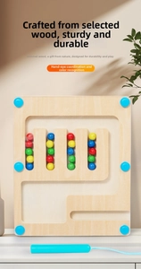 Close-up of wooden magnetic pen maze board with colorful beads for logic training