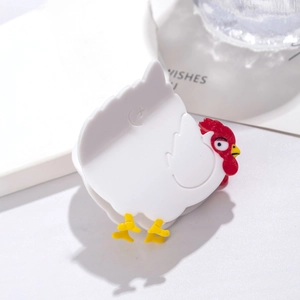 Close-up of white rooster-shaped acetate hair claw clip with detailed animal design