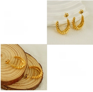 Detail of 18K gold plated titanium steel hoop earrings with spiral croissant texture