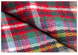 Close-up of tartan wool blend fabric texture for children's plaid poncho shawl