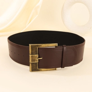 Vintage dark brown leather wide belt for women with retro brass buckle on beige fabric