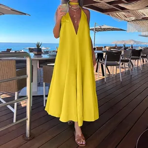 Fashionable bright yellow V-neck halter maxi dress with flowing A-line skirt for beach vacations