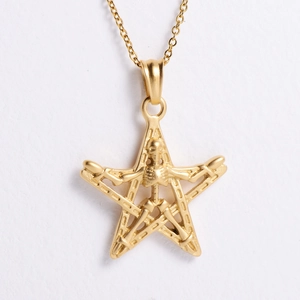 Macro shot of 18K gold star and skull pendant showing gothic punk metal textures