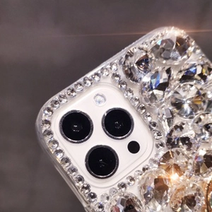 Close-up of sparkling rhinestones and camera lens protection on luxury iPhone case